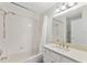 Well-lit bathroom with shower and bathtub combination, complemented by modern fixtures and vanity at 15746 Autumn Glen Ave, Clermont, FL 34714