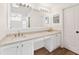 A bright bathroom featuring double sinks, a vanity, white cabinetry and modern fixtures at 15746 Autumn Glen Ave, Clermont, FL 34714
