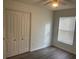 Bedroom featuring a ceiling fan, closet, window, and wood-look flooring at 15746 Autumn Glen Ave, Clermont, FL 34714