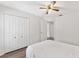 Neutral bedroom with a ceiling fan, closet, and access to other rooms within the home at 15746 Autumn Glen Ave, Clermont, FL 34714