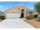 Charming single-story home with a well-maintained front yard and attached two-car garage at 15746 Autumn Glen Ave, Clermont, FL 34714