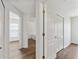 Hallway showcasing multiple entryways and closet space with modern flooring throughout the home at 15746 Autumn Glen Ave, Clermont, FL 34714