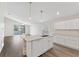 Open kitchen with an island, pendant lighting, white cabinets, and stainless steel appliances at 15746 Autumn Glen Ave, Clermont, FL 34714
