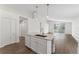 Open kitchen and living space with bright interiors and stainless steel appliances at 15746 Autumn Glen Ave, Clermont, FL 34714