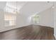 Spacious living room featuring new flooring, bright lighting, and an open floor plan at 15746 Autumn Glen Ave, Clermont, FL 34714