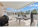The covered patio features ample seating, a barbecue, and a view of the surrounding landscape at 15746 Autumn Glen Ave, Clermont, FL 34714
