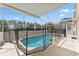 Sparkling pool with protective fencing within screened enclosure, perfect for relaxation and fun at 15746 Autumn Glen Ave, Clermont, FL 34714