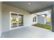 Covered back patio with a sliding glass door, offering a great outdoor space for entertaining or relaxing at 1639 Pickerel Ct, Kissimmee, FL 34759