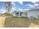 Spacious backyard with a covered patio, offering a private outdoor retreat and plenty of space for activities at 1639 Pickerel Ct, Kissimmee, FL 34759
