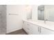 Modern bathroom featuring double sinks, a granite countertop vanity, and a tiled walk-in shower at 1639 Pickerel Ct, Kissimmee, FL 34759
