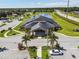 An aerial view shows the clubhouse and parking area with palm trees in an attractive manicured landscape at 1639 Pickerel Ct, Kissimmee, FL 34759