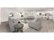 Bright open-concept living area featuring modern furnishings, hardwood floors, and a seamless flow to the kitchen at 1639 Pickerel Ct, Kissimmee, FL 34759