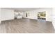 Expansive living space with wood flooring, leading to a bright kitchen and a sliding glass door at 1639 Pickerel Ct, Kissimmee, FL 34759