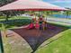 An aerial view of the playground shows colorful slides, climbing structures, and shade at 1639 Pickerel Ct, Kissimmee, FL 34759