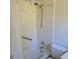Clean, white tiled bathroom with shower, tub, toilet, and grab bar at 1661 Votaw Rd, Apopka, FL 32703