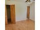 Bright bedroom with light hardwood floors, white walls, ceiling fan, and closet at 1661 Votaw Rd, Apopka, FL 32703