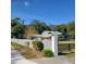 Gray single Gathering home with gray wall, black fence, lush trees, and blue sky at 1661 Votaw Rd, Apopka, FL 32703