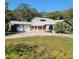 Gray single Gathering home with lawn and mature trees at 1661 Votaw Rd, Apopka, FL 32703