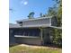 Side view of home featuring gray siding, sun shades, and a well-maintained lawn at 1661 Votaw Rd, Apopka, FL 32703