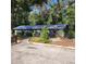 Charming single-story home with a metal roof, lush landscaping, and a walkway leading to the entrance at 1661 Votaw Rd, Apopka, FL 32703