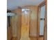 Hallway featuring wood paneling, wood floors, and access to multiple rooms at 1661 Votaw Rd, Apopka, FL 32703