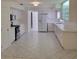 Spacious white kitchen with ample counter space, stainless appliances, and tile flooring at 1661 Votaw Rd, Apopka, FL 32703