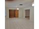 A bright living room with tile flooring, built in shelving, and ceiling fan at 1661 Votaw Rd, Apopka, FL 32703