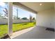 Covered back porch with a view of the backyard and privacy wall at 19318 Banfield Pl, Orlando, FL 32827
