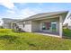 Spacious backyard featuring a covered patio with sliding glass doors that connect to the indoor living space at 19318 Banfield Pl, Orlando, FL 32827