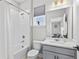 Bright bathroom featuring a shower-tub combo, a modern vanity, and a window offering natural light at 19318 Banfield Pl, Orlando, FL 32827