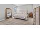 Cozy bedroom with a plush bed, mirrored dresser, and ample natural light at 19318 Banfield Pl, Orlando, FL 32827