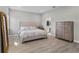 Spacious bedroom with a luxurious upholstered bed and wood-look floors at 19318 Banfield Pl, Orlando, FL 32827