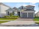 Charming two-story home with a well-manicured lawn and brick paver driveway at 19318 Banfield Pl, Orlando, FL 32827