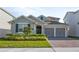 Charming single-Gathering home showcasing a well-manicured lawn, two-car garage and welcoming entrance at 19318 Banfield Pl, Orlando, FL 32827