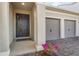 Inviting front entrance with gray door, brick paver driveway, and two-car garage at 19318 Banfield Pl, Orlando, FL 32827