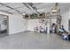 Epoxy-floored garage with overhead storage, a side door, and plenty of space for bikes and other equipment at 19318 Banfield Pl, Orlando, FL 32827
