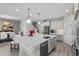 Bright, modern kitchen featuring a large island, pendant lighting, and stainless steel appliances at 19318 Banfield Pl, Orlando, FL 32827
