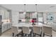 Bright, modern kitchen featuring a large island, pendant lighting, and stainless steel appliances at 19318 Banfield Pl, Orlando, FL 32827