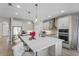 Bright, modern kitchen featuring a large island, pendant lighting, and stainless steel appliances at 19318 Banfield Pl, Orlando, FL 32827