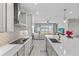 Spacious kitchen with an island, modern appliances, decorative backsplash, and easy access to the living area at 19318 Banfield Pl, Orlando, FL 32827