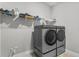 Laundry room with front-load washer and dryer and shelving for supplies at 19318 Banfield Pl, Orlando, FL 32827