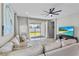 Living room featuring a large sofa, view of the backyard, and a modern ceiling fan at 19318 Banfield Pl, Orlando, FL 32827