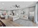 Bright living room with a large sectional sofa, modern art, and an open view to the kitchen area at 19318 Banfield Pl, Orlando, FL 32827
