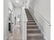 Carpeted staircase with white banister leading to the upper level at 19318 Banfield Pl, Orlando, FL 32827