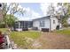 Wide-open backyard with a screened-in porch, storage and mature landscaping at 1938 Eastbrook Blvd, Winter Park, FL 32792