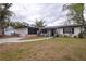 Charming single-story home featuring a welcoming front porch, attached garage, and well-maintained lawn at 1938 Eastbrook Blvd, Winter Park, FL 32792