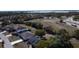 Aerial view of residential community near a large open recreational area with a school bus on a road at 1956 Myakka Ct, Poinciana, FL 34759
