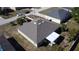 An elevated view of a home featuring a pristine gray roof and back patio in a neighborhood with mature trees at 1956 Myakka Ct, Poinciana, FL 34759