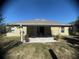 Backyard patio with outdoor seating and a view of the home, perfect for relaxation and entertaining at 1956 Myakka Ct, Poinciana, FL 34759