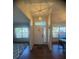 Spacious entryway with hardwood flooring, decorative lighting, and an open view into the dining and living spaces at 1956 Myakka Ct, Poinciana, FL 34759
